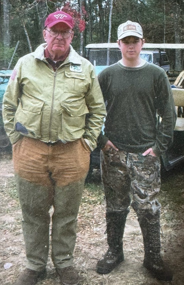 Samuel Price as a teenager beside his grandfather at a hunt camp, from a family print